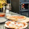 ESSE garden stove pizza and wine on table